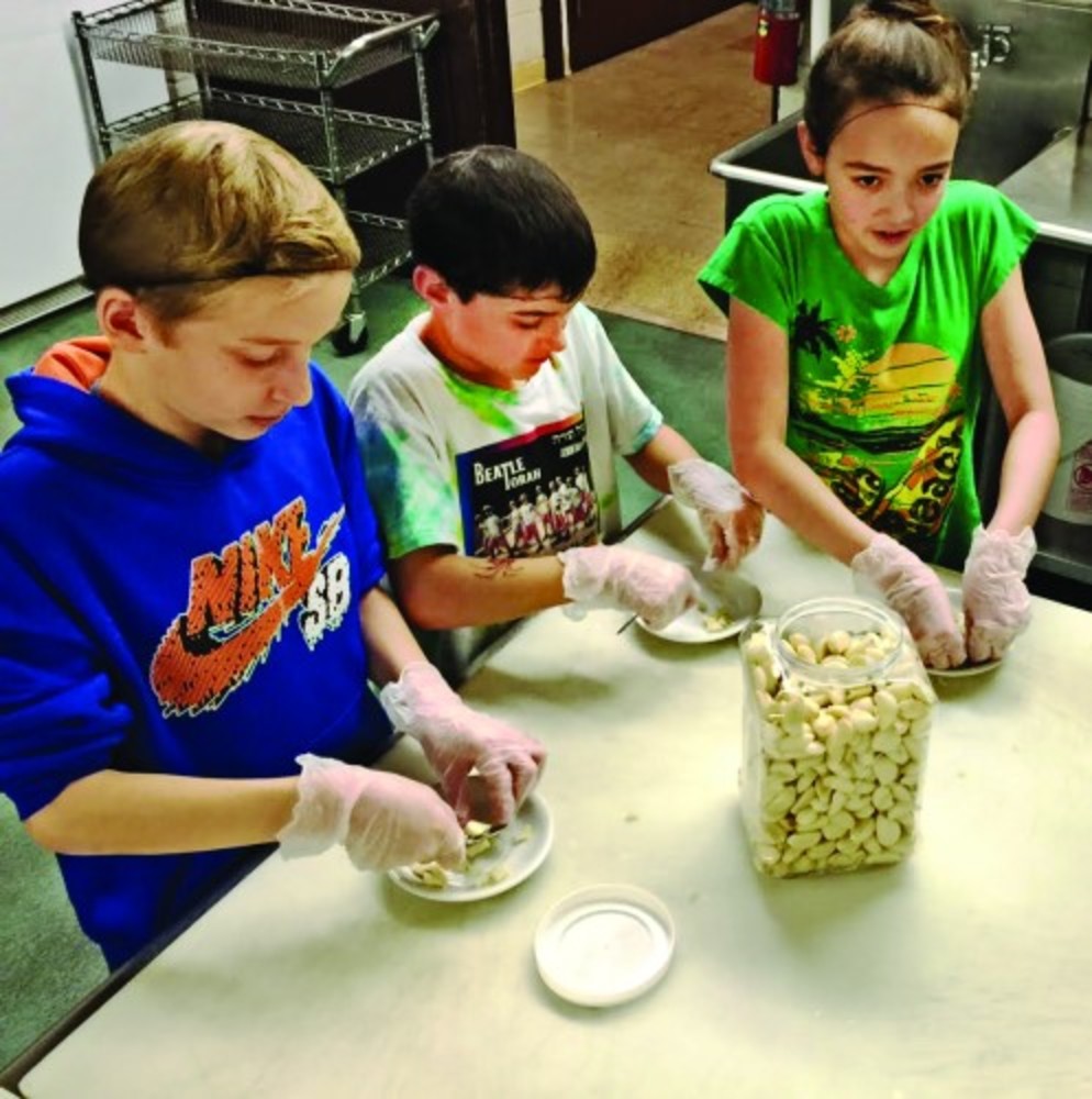 JCDS fifth graders prepare the garlic for their pickles. /JCDSRI